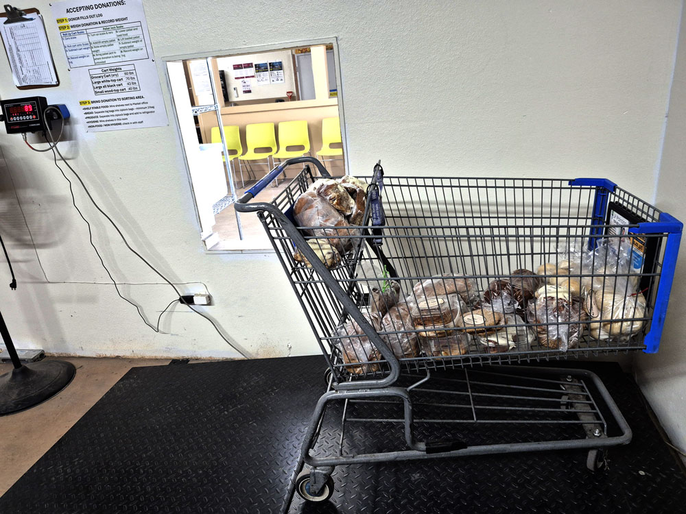 Cart of donated items being weighed on scale