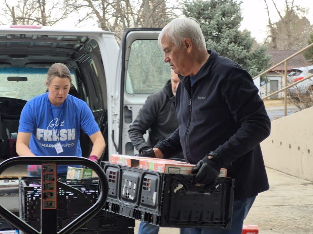 Volunteers help unload a donations made to IFCS